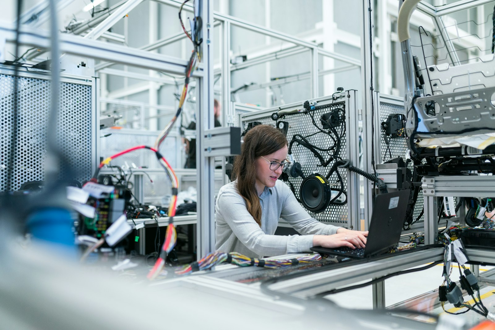 Engineer working on a laptop at a production line